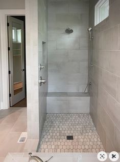 a walk in shower sitting inside of a bathroom