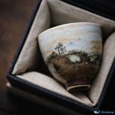 a small cup in a box on top of a table