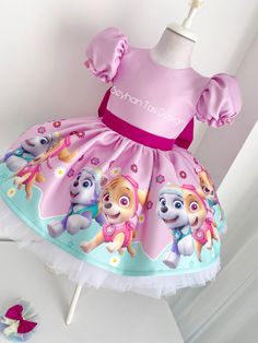 a pink dress with paw patrol on it