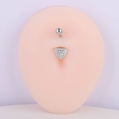 This Glitter Heart Belly Ring is just what your outfit needs for an extra touch of sparkle! Crafted with stainless steel, this fun piece is adorned with Cubic Zirconia for a hint of extra bling. Get it and show the world you're a-heart! 💗 Detail： -Post material: stainless steel -Gauge: 14g | 1.6mm -Post length: 10mm -Ball diameter: 5mm -Heart dimensions: 8.2mm Length x 9.2mm Width -Include: single item *For healed piercings* Belly Ring, Glitter Hearts, Belly Rings, Piercings, Cubic Zirconia, Sparkle, Glitter, Stainless Steel, Ring