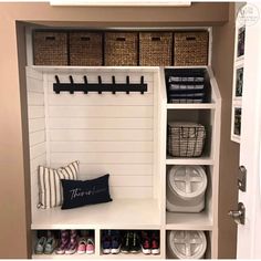 an organized mud room with baskets and shoes