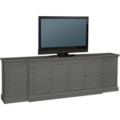 a flat screen tv sitting on top of a gray entertainment center with doors and drawers