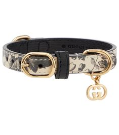 the gucci belt with gold buckles is shown in black and white floral print