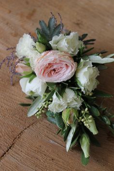 a bouquet of flowers sitting on top of a wooden table