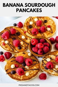 pancakes topped with raspberries and chocolate chips on a white plate