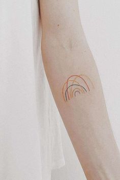 a person's arm with a tattoo on it that has circles painted on it