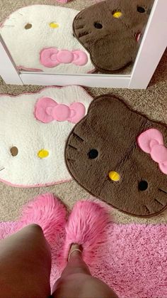 hello kitty bathroom rugs and slippers are on the floor in front of a mirror