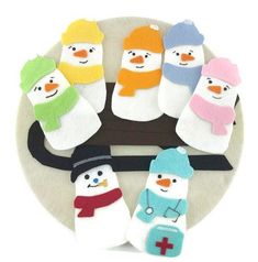 six snowmen with hats and scarfs on a plate