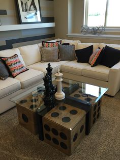 a living room filled with furniture and a chess board on top of a coffee table