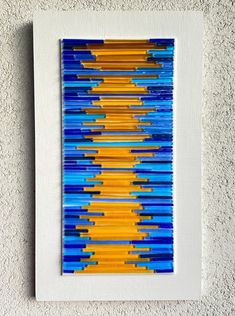 an abstract painting with blue, yellow and orange lines on the bottom half of it