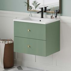 a bathroom vanity with a mirror above it and a bag on the floor next to it