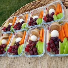 several plastic containers filled with fruits and vegetables