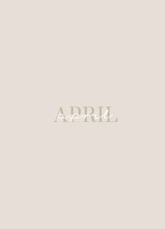 the word april written in white on a beige background