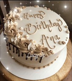 a birthday cake with frosting and flowers on it