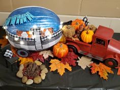 a table topped with pumpkins and fall decorations