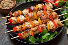 chicken kabobs on skewers with peppers and cilantro