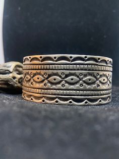 Handmade Native American Navajo overlay plain sterling silver stamped heavy cuff bracelet. Stamped sterling & signed by artist.  Bracelet is very gorgeous with lots of silver designs.  The silver is patina giving the bracelet a vintage look.  Bracelet has nice silver. Heavy.  Metal used: Sterling Silver From one end to the other the bracelet is approximately 5 3/4 inch's. The opening of the bracelet is approximately 1 3/8 inch's. The bracelet is approximately 1 1/8 inch wide.  Weight: 102.1 grams. Handmade in New Mexico, USA THANK YOU FOR SHOPPING NATIVE GEMS 100% CUSTOMER SATISFACTION GUARANTEED B Bohemian Silver Hand Stamped Bracelets, Bohemian Stamped Sterling Silver Bracelet, Silver Hand-tooled Artisan Cuff Bracelet, Silver Artisan Hand-tooled Cuff Bracelet, Artisan Silver Cuff Bracelet Hand Tooled, Silver Bohemian Hand Tooled Bracelets, Bohemian Silver Hand Tooled Bracelets, Artisan Hand-tooled Silver Cuff Bracelet, Bohemian Silver Stamped Cuff Bracelet