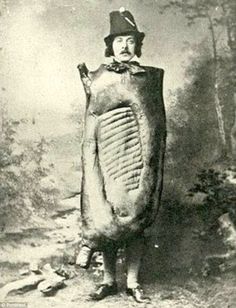 an old black and white photo of a man dressed as a giant egg in the woods