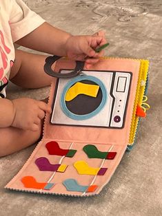 a baby is playing with a toy on the floor