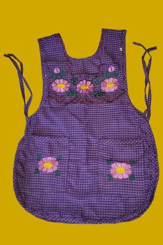 a purple apron with flowers on it