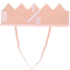 a pink glitter headband with the number twenty two on it's side and an arrow at the top