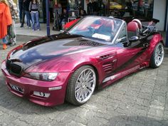 a purple bmw z4 convertible parked on the street