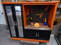 an orange cabinet with tools on it in a garage