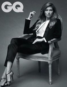 a woman sitting on top of a chair in a black and white photo with the word go written above her