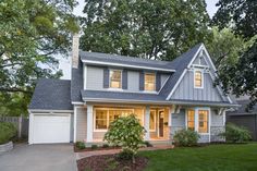 a gray house with white trim and windows