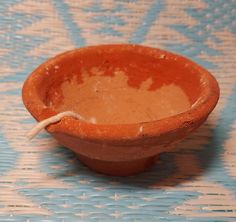 a brown bowl sitting on top of a blue table