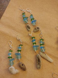 These earrings have natural beach hag (holey) stones from Florida. The beads are sea glass, vintage sea glass from Indonesia and freshwater pearls. The 925 stainless steel clasps are hypoallergenic. Nickel-free Glass Jewelry For Beach, Nickel-free Glass Jewelry For The Beach, Turquoise Sea Glass Jewelry For Beach, Unique Recycled Glass Beach Jewelry, Unique Recycled Glass Jewelry For Beach, Green Jewelry With Matching Earrings For The Beach, Beach Sea Glass Earrings With Ear Wire, Beach Earrings With Sea Glass And Ear Wire, Nature-inspired Beach Jewelry With Natural Stones