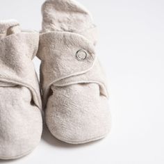 Hand crafted booties, made locally here in Cape Elizabeth, Maine. Extra soft organic fleece liner and snap enclosure ensures that these cuties stay on! 0-3, 3-6 have a cloth bottom Size 6-12 have a rubber sole for walking Handmade in Cape Elizabeth, Maine 100% organic cotton fleece Cotton and linen shell Comfortable Soft Booties For Playtime, Comfortable Soft Booties With Round Toe, Comfortable Soft Round Toe Booties, Comfortable Cream Winter Booties, Comfortable Winter Booties With Soft Sole, Cream Booties With Soft Sole For Spring, Casual Closed Toe Booties With Soft Sole, Cape Elizabeth Maine, Toddler Outerwear