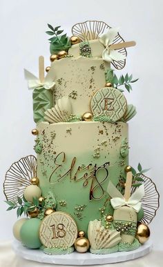 a three tiered cake decorated with sea shells and seashells is on display