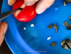 someone cutting up a piece of food on top of a blue plate