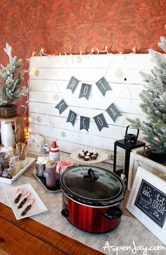 a crock pot sitting on top of a table next to christmas decorations and other items