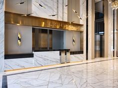 the entrance to a building with marble floors and walls