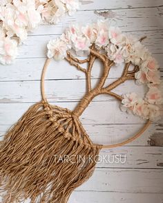 this is an image of a tree with flowers in the branches on a white wooden background