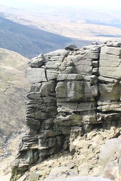 a man standing on top of a rocky cliff