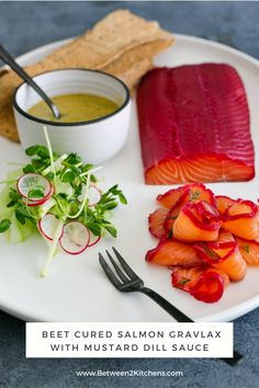 a white plate topped with salmon and salad