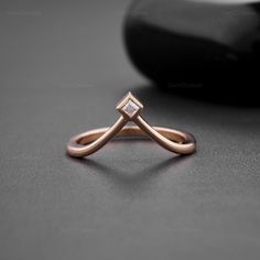 a diamond ring sitting on top of a table