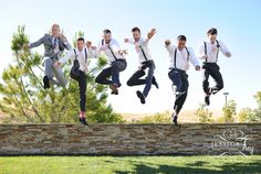 a group of men jumping in the air with their arms and legs spread wide open