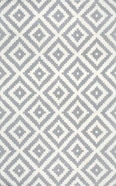 a gray and white rug with diamonds on it