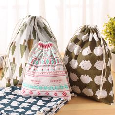 three bags sitting on top of a wooden table