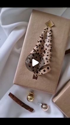 a gift wrapped in brown paper with a polka dot christmas tree on it and other holiday decorations