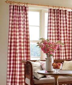 a living room with red and white checkered curtains