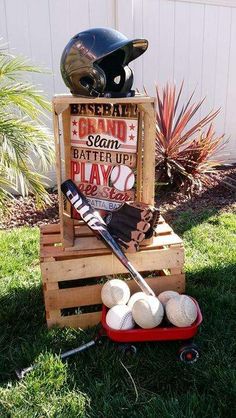 a wooden crate filled with baseball equipment and balls