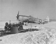 an old airplane sitting on top of snow covered ground