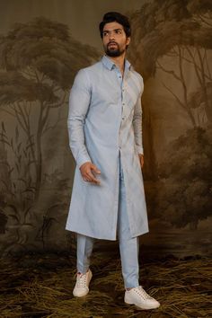 Blue kurta with thread embroidered criss cross patterns. Comes with pant.
Components: 2
Pattern: Embroidered
Type Of Work: Criss Cross
Neckline: Mandarin Collar
Sleeve Type: Full
Fabric: Cotton Silk
Color: Blue
Other Details: 
Straight silhouette
Closure: Kurta: Front button
Occasion: Mehendi and Puja,Sangeet - Aza Fashions Menswear Kurta, Blue Kurta, Kurta With Pants, Cross Patterns, Embroidered Silk, Mandarin Collar, Cotton Silk, Aza Fashion, Fabric Cotton