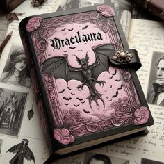 a pink and black book with bats on it