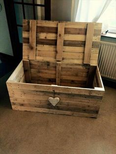 an empty wooden box sitting on the floor